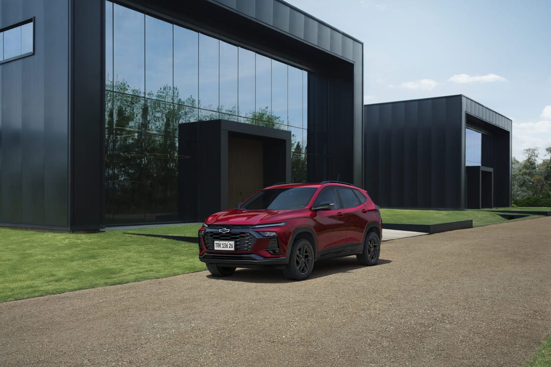 SUV vermelho estacionado em frente a casa moderna, ideal como carro para família.